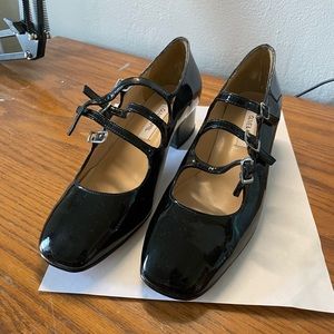 Glossy black genuine leather 3-strap Mary janes.